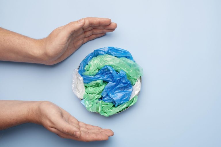 close-up-hand-with-plastic-earth PA/PE