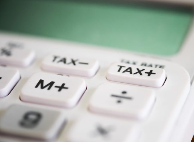 Close up of tax button on business white calculator - Plastic Packaging Tax