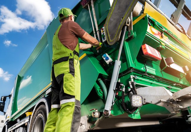 worker unloading garbage - PackUK