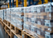 Warehouse pallets with stretch film wrap showcasing the logistical challenges of PPWR Article 29 reuse mandates.