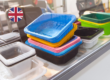 Colourful plastic food contact containers displayed on a shelf with a UK flag icon, illustrating the FSA's postponement of the BPA restriction in food contact materials.