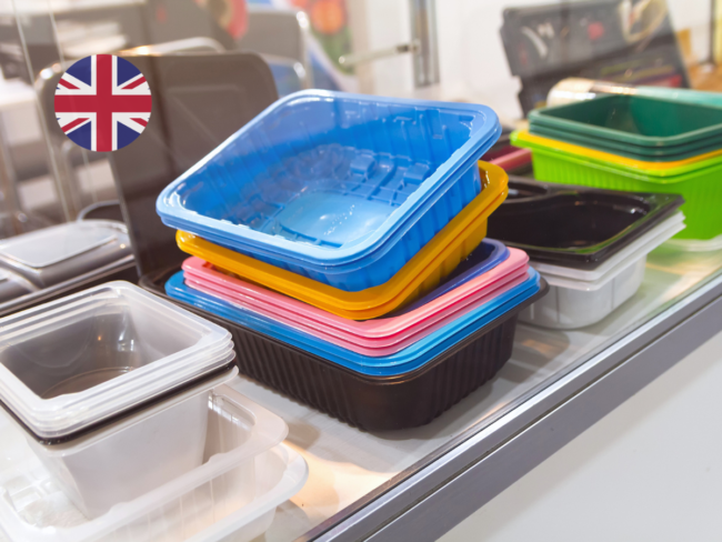 Colourful plastic food contact containers displayed on a shelf with a UK flag icon, illustrating the FSA's postponement of the BPA restriction in food contact materials.
