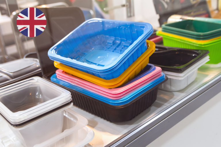 Colourful plastic food contact containers displayed on a shelf with a UK flag icon, illustrating the FSA's postponement of the BPA restriction in food contact materials.