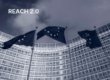 EU flags in front of the Berlaymont building in Brussels with "REACH 2.0" text overlay, illustrating the EU Commission's decision to shelve the REACH 2.0 revision.