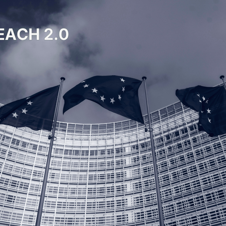 EU flags in front of the Berlaymont building in Brussels with "REACH 2.0" text overlay, illustrating the EU Commission's decision to shelve the REACH 2.0 revision.