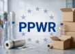 Packaging materials including plastic bottles, cardboard boxes and shrink wrap arranged around the PPWR logo against a EU stars background, illustrating PPWR enforcement challenges ahead of the August 2026 deadline.