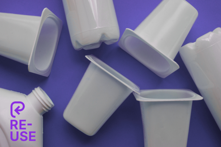 Reusable plastic containers and bottles scattered on a purple background with the PR3 reuse symbol overlay, illustrating the new global reuse packaging symbol launched by PR3: The Global Alliance to Advance Reuse.