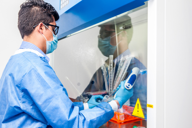 A researcher working in a laboratory safety cabinet, illustrating the NTU Singapore research behind the DIPS solvent-free method for mixed plastic packaging recycling.