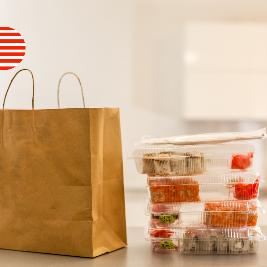 Stacked plastic food containers next to a paper bag with a US flag icon, illustrating the No Toxics in Food Packaging Act targeting PFAS, phthalates and BPA in food contact materials.