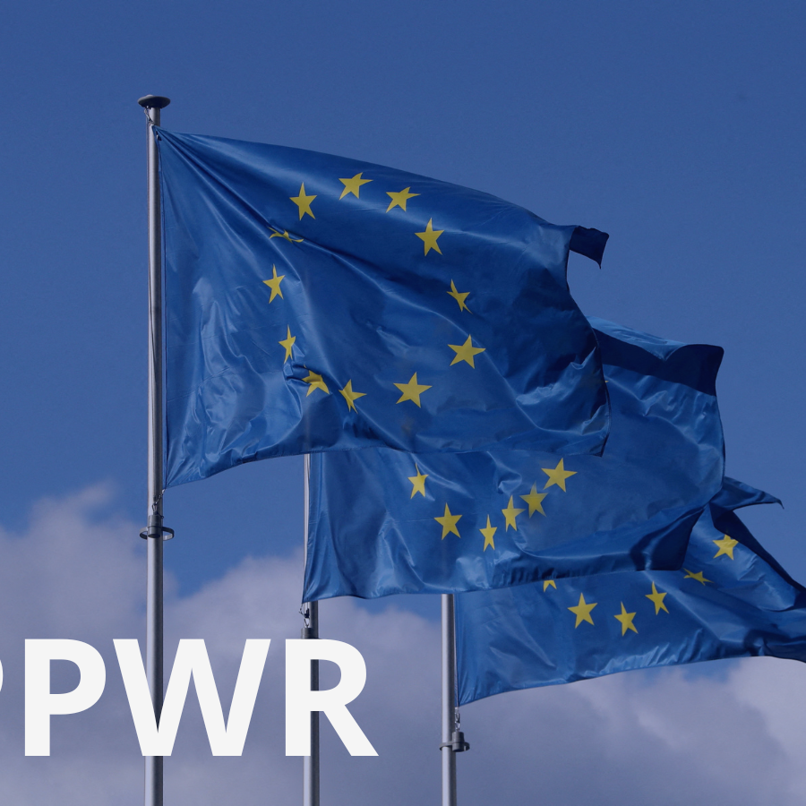 EU flags against a blue sky with "PPWR" text overlay, illustrating the industry coalition urging the EU Commission not to reopen the PPWR revision ahead of its August 2026 application date.