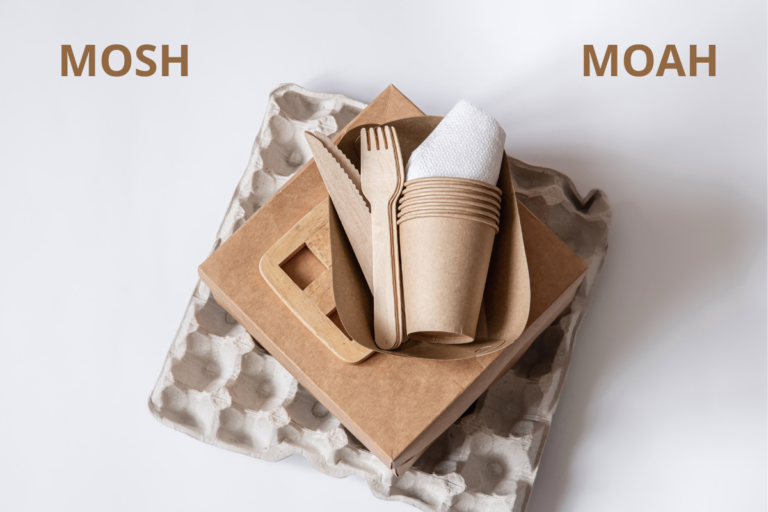 Stack of recyclable paper and cardboard food packaging items, including egg cartons, takeaway boxes, paper cups, wooden cutlery and napkins, arranged on a white background – materials commonly tested for MOSH and MOAH mineral oil contamination