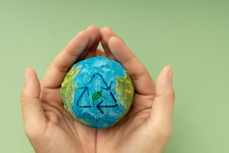 Hands holding a globe with a recycling symbol, representing the call for a harmonized EU EPR framework under the Circular Economy Act